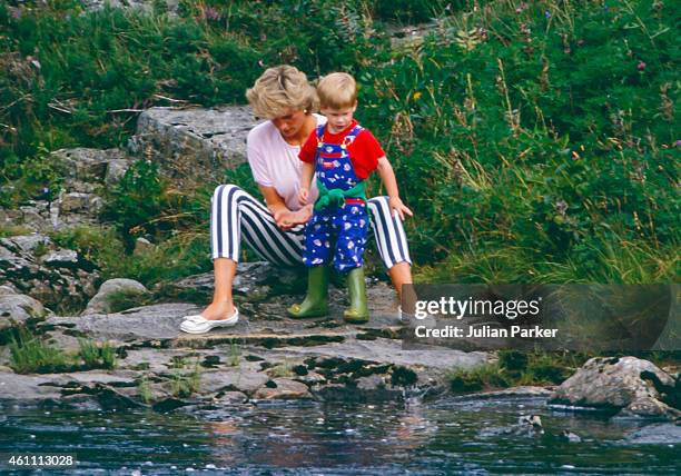 Diana, Princess of Wales, and Prince Harry play on the banks of the River Dee, near Balmoral Castle.during a Summer vacation, on August 18 in...