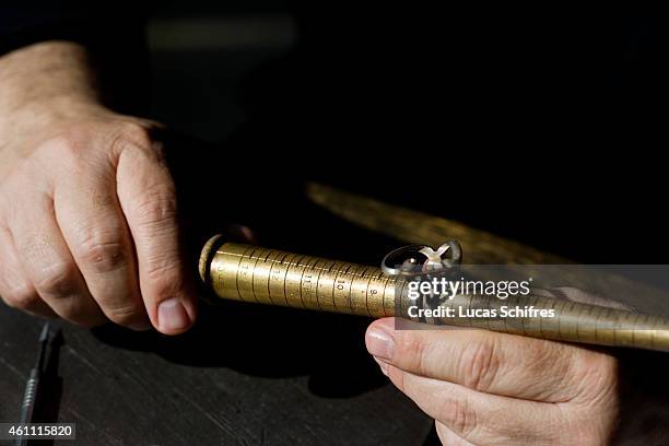 January 28: A Ganaelle jewelry craftsman works on a ring to make a jewel at his workstation at a Ganaelle Jewelry workshop on January 28, 2011 in...