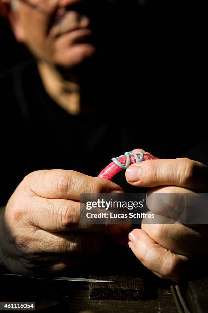 January 28: A Ganaelle jewelry craftsman works on a bracelet to make a jewel at his workstation at a Ganaelle Jewelry workshop on January 28, 2011 in...