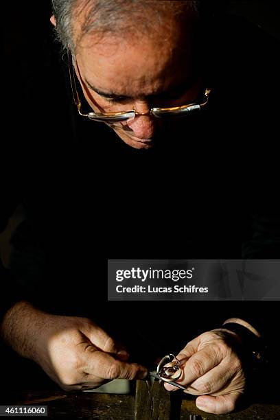 January 28: A Ganaelle jewelry craftsman works on a ring to make a jewel at his workstation at a Ganaelle Jewelry workshop on January 28, 2011 in...