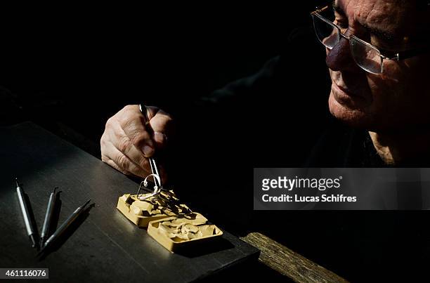 January 28: A Ganaelle jewelry craftsman works on a ring to make a jewel at his workstation at a Ganaelle Jewelry workshop on January 28, 2011 in...