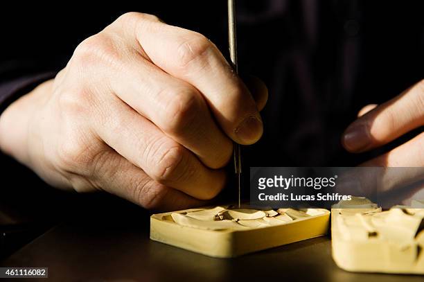 January 28: A Ganaelle jewelry craftsman works on a ring to make a jewel at his workstation at a Ganaelle Jewelry workshop on January 28, 2011 in...