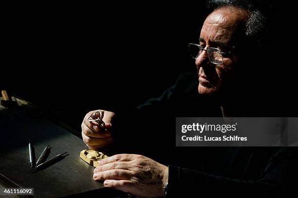 January 28: A Ganaelle jewelry craftsman works on a ring to make a jewel at his workstation at a Ganaelle Jewelry workshop on January 28, 2011 in...