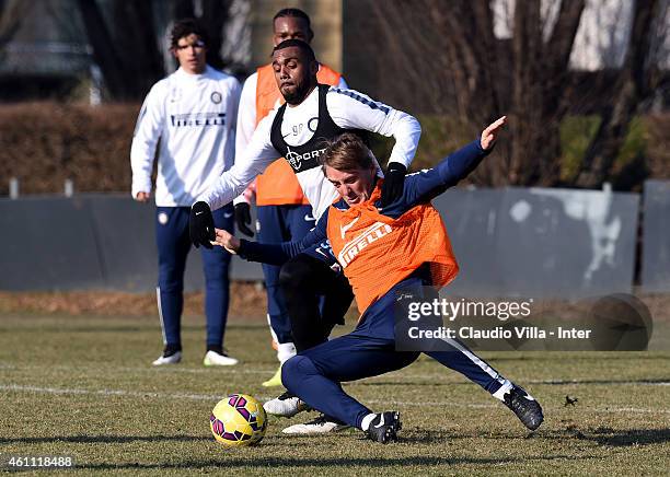 Head coach Roberto Mancini and Yann M'Vila compete for the ball during the FC Internazionale Training Session at Appiano Gentile on January 07, 2015...