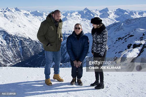 British actor Daniel Craig jokes with his colleagues Lea Seydoux of France and US Dave Bautista with Tyrolean Alps in the background during a photo...