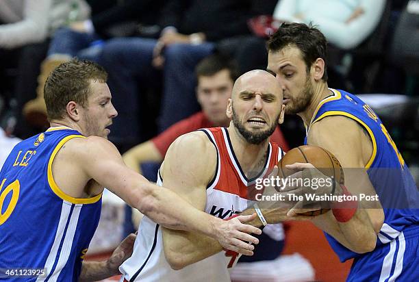 Golden State Warriors power forward David Lee , left, an dGolden State Warriors center Andrew Bogut right, work to steal the rebound from Washington...