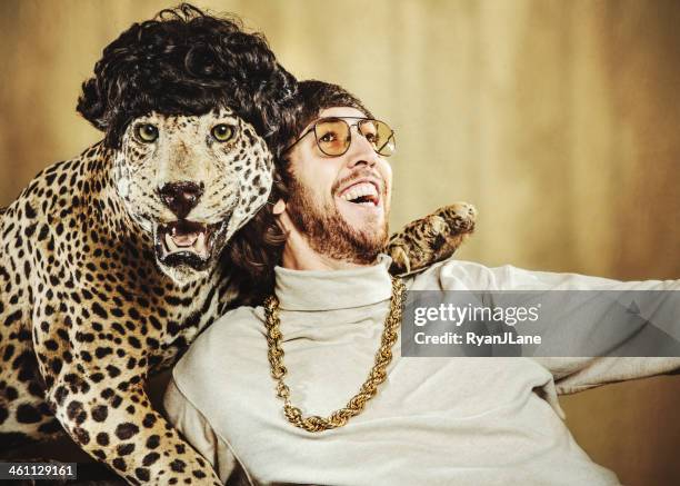 retro man poses with wig wearing leopard - cat with collar stockfoto's en -beelden