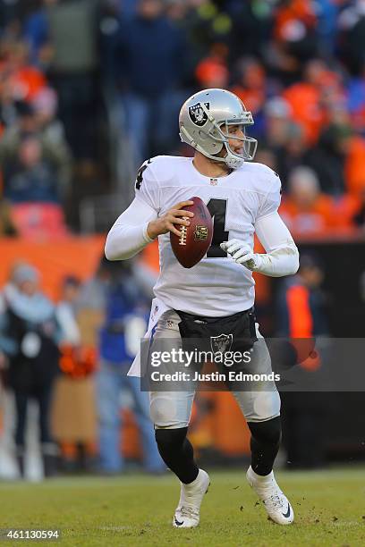 Quarterback Derek Carr of the Oakland Raiders in action against the Denver Broncos at Sports Authority Field at Mile High on December 28, 2014 in...