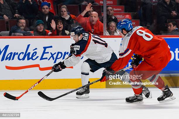 Martin Reway of Team Slovakia tries to carry the puck with David Nemecek of Team Czech Republic following in a quarterfinal round during the 2015...