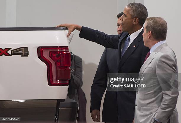 President Barack Obama looks at a Ford pickup truck prior to speaking about the automotive manufacturing industry at the Ford Michigan Assembly Plant...