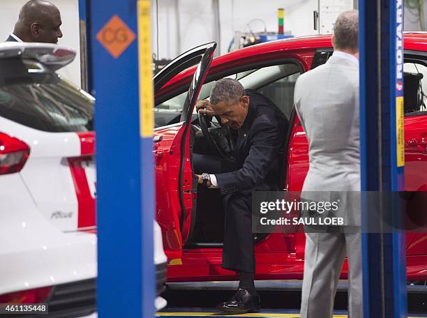 President Barack Obama exits a Ford car prior to speaking about the automotive manufacturing industry at the Ford Michigan Assembly Plant in Wayne,...
