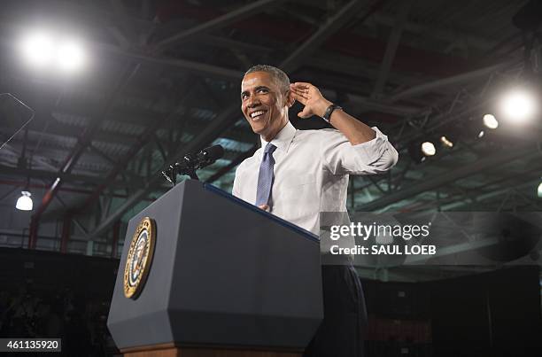 President Barack Obama gestures to hear the crowd as he speaks about the automotive manufacturing industry at the Ford Michigan Assembly Plant in...