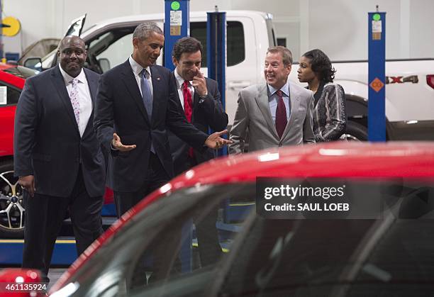 President Barack Obama looks at Ford vehicle before speaking about the automotive manufacturing industry at the Ford Michigan Assembly Plant in...