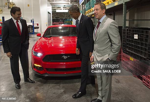 President Barack Obama looks at a Ford Mustang alongside Bill Ford and Mark Fields , President and CEO of Ford, prior to speaking about the...