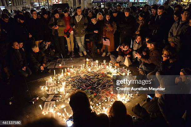 People gather around candles and pens at the Place de la Republique in support of the victims after the terrorist attack earlier today on January 7,...