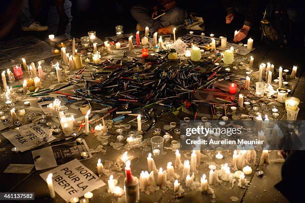 People gather around candles and pens at the Place de la Republique in support of the victims after the terrorist attack earlier today on January 7,...