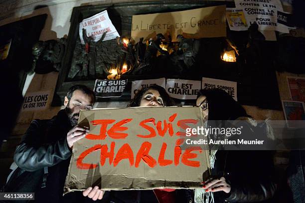 Supporters display placards during a gathering at the Place de la Republique in support of the victims after the terrorist attack earlier today on...