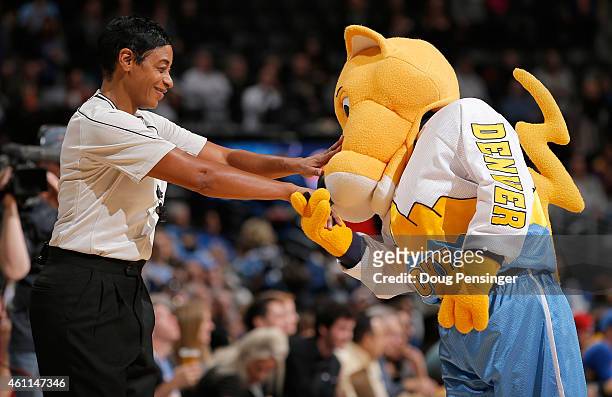 Super mascot Rocky of the Denver Nuggets welcomes referee Violet Palmer as she oversees the action between the Orlando Magic and the Denver Nuggets...