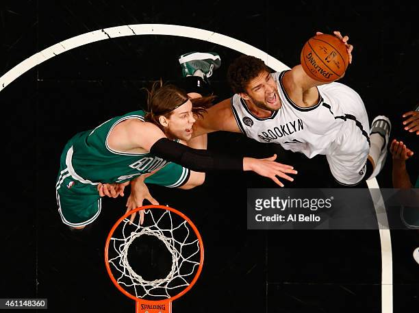 Kelly Olynyk of the Boston Celtics and Brook Lopez of the Brooklyn Nets battle for a rebound during their game at the Barclays Center on January 7,...