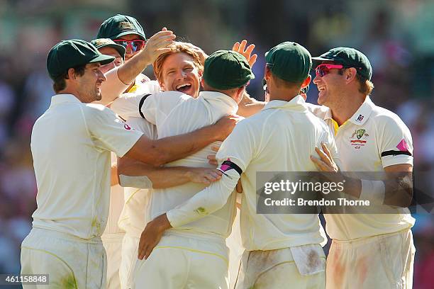 Shane Watson of Australia celebrates with team mates after claiming the wicket of Suresh Raina of India during day three of the Fourth Test match...