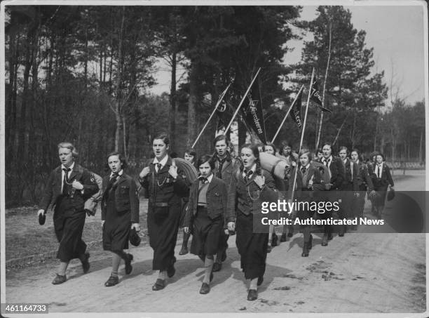 German school children marching through a forest as part of practice military games, as part of Hitler Youth during World War Two, Germany, circa...