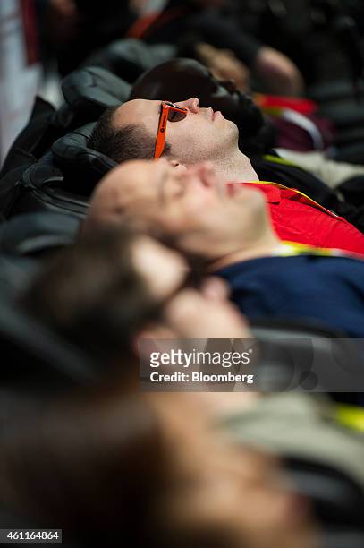 Attendees rests during the 2015 Consumer Electronics Show in Las Vegas, Nevada, U.S., on Wednesday, Jan. 7, 2015. This year's CES will be packed with...