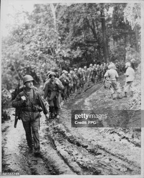 Troops marching towards a Japanese occupied airfield in Cape Gloucester during the Pacific Campaign of World War Two, New Britain, circa 1943.