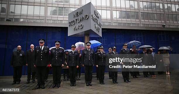 Members of the Metropolitan Police Service observe two minutes silence at New Scotland Yard on January 8, 2015 in London, England. France is on...