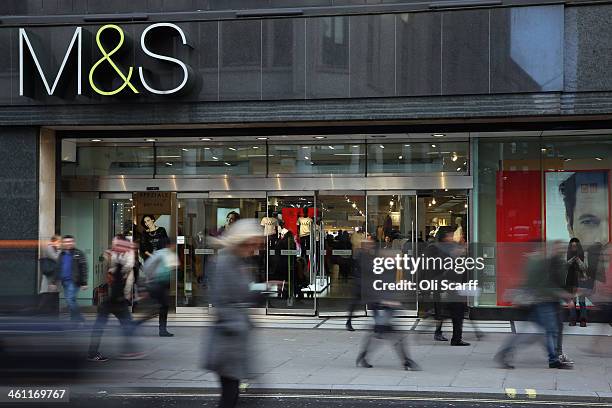 Members of the public walk past a branch of Marks & Spencer on January 7, 2014 in London, England. The food and clothing retailer, which has traded...