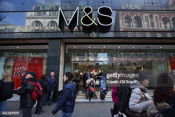 Members of the public walk past a branch of Marks & Spencer on January 7, 2014 in London, England. The food and clothing retailer, which has traded...