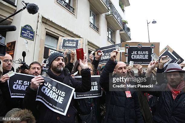 French journalists observe a minute's silence at noon close to the Charlie Hebdo offices on a day of mourning following a terrorist attack in the...
