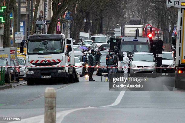 French police officeres stand at the scene after a female police officer was shot dead in Montrouge, a southern suburb of Paris on January 8 a day...