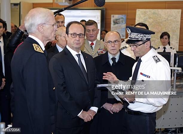 French President Francois Hollande and French Interior Minister Bernard Cazeneuve visit the control room of the Paris Prefecture on January 8, 2015...