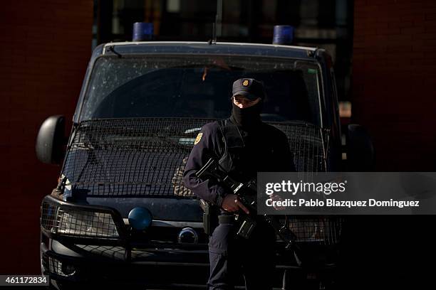 An armed policeman stands guard outside Atocha Train Station after yesterday's terrorist attack in Paris on January 8, 2015 in Madrid, Spain....