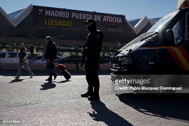 An armed policeman stands guard outside Atocha Train Station after yesterday's terrorist attack in Paris on January 8, 2015 in Madrid, Spain....