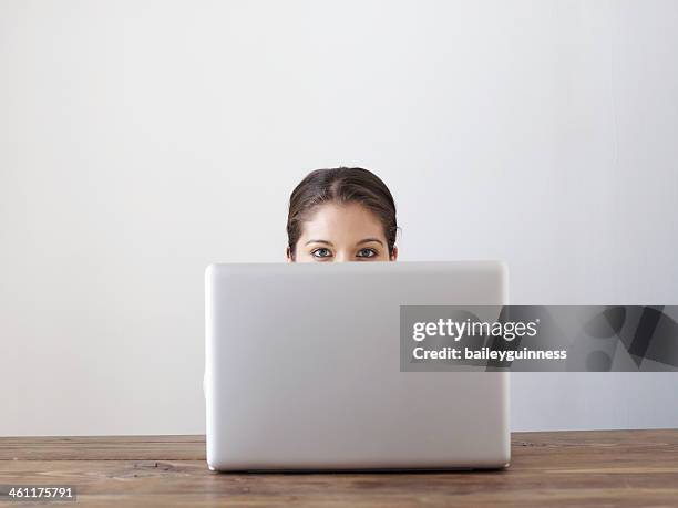 woman behind laptop - posteriore foto e immagini stock