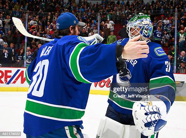 Daniel Sedin of the Vancouver Canucks looks on as Casey Cizikas of the New York Islanders passes the puck up ice during their NHL game at Rogers...