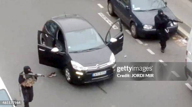 Frame grab taken from a footage made available and posted by Jordi Mir, a local resident, on January 7, 2015 shows hooded gunmen aiming Kalashnikov...