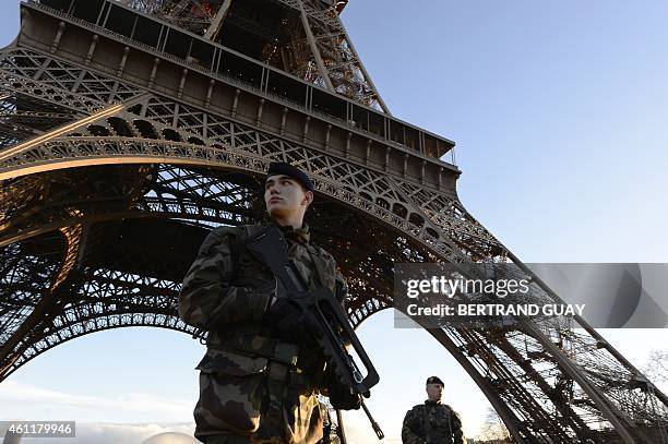 French soldiers patrol in front of the Eiffel Tower on January 8, 2015 in Paris as the capital was placed under the highest alert status a day after...