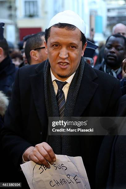 Hassen Chalghoumi, Imam of the Drancy mosque in Paris holds a poster saying 'Je suis Charlie' near the 'Charlie Hebdo' offices on a day of mourning...