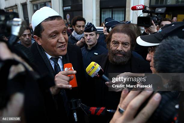 Hassen Chalghoumi, Imam of the Drancy mosque in Paris and philosopher Marek Halter speak to media near the 'Charlie Hebdo' offices on a day of...