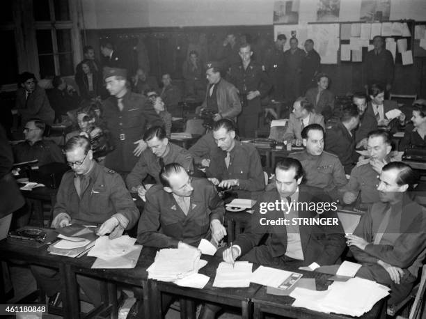 Journalists, gathering at the pressroom, are seen working after attending the execution by hanging of the nazi war criminals during the Nuremberg...