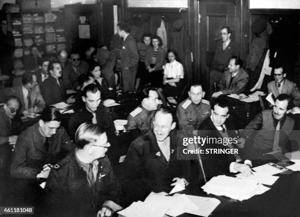 Journalists, gathering at the pressroom, are seen working after attending the execution by hanging of the nazi war criminals during the Nuremberg...