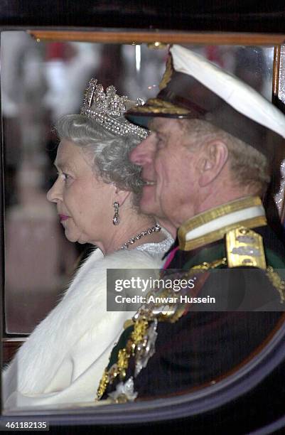 Queen Elizabeth II and Prince Philip, Duke of Edinburgh leave Buckingham Palace by coach to attend the State Opening of Parliament on December 06,...