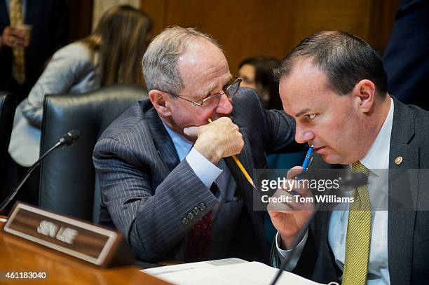 Sens. Jim Risch, R-Idaho, left, and Mike Lee, R-Utah, confer before a Senate Energy and Natural Resources Committee markup in Dirksen Building on...