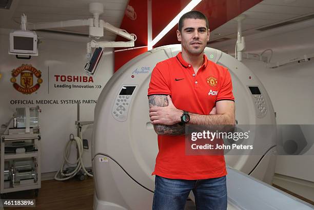 Victor Valdes of Manchester United poses in front of some medical equipment after signing for the club at Aon Training Complex on January 8, 2015 in...