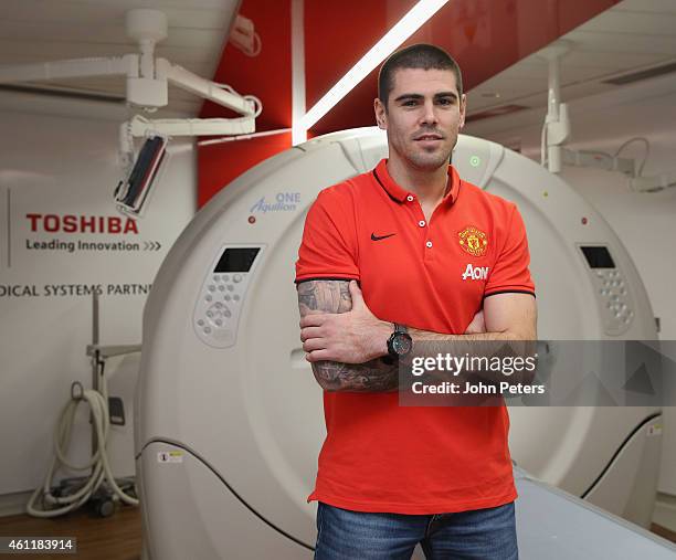 Victor Valdes of Manchester United poses in front of some medical equipment after signing for the club at Aon Training Complex on January 8, 2015 in...