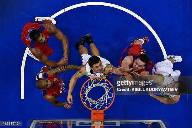 Moscow's players Aaron Jackson and Sasha Kaun fight for the ball with Laboral Kutxa Vitoria's player Mike James during their Euroleague Top-16 group...