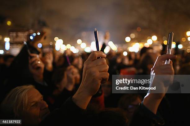 People hold up pens during a vigil at the Place de la Republique for victims of the terrorist attack, on January 8, 2015 in Paris, France. Twelve...
