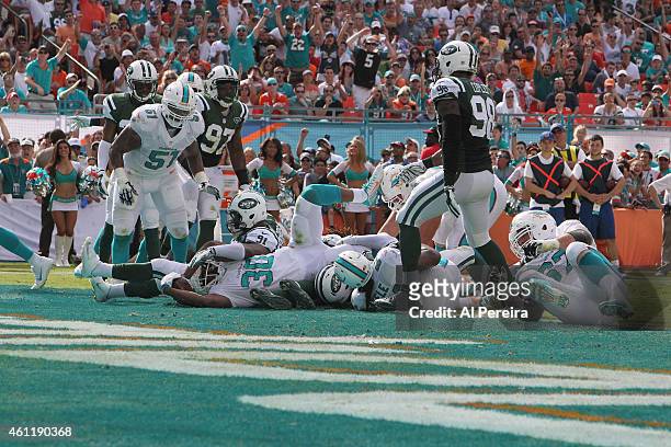 Running Back Daniel Thomas of the Miami Dolphins scores a touchdown against the New York Jets at Sun Life Stadium on December 28, 2014 in Miami...